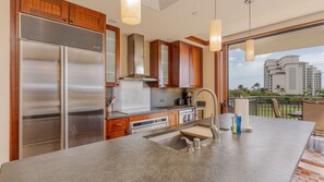 Prep meals easily in the gourmet kitchen at Ko Olina Beach Villas O425 with top appliances.
