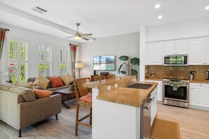 Plenty of seating and natural lighting in this seamless living and kitchen area.