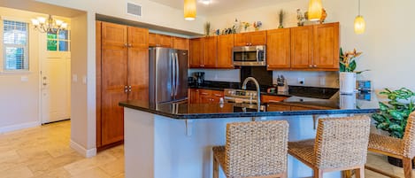 The open floor kitchen with breakfast bar seating.