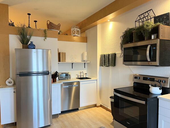 Our kitchen has new full size stainless steel appliances.