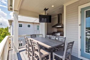 3rd floor balcony with eating space for 8 people and a Suera Outdoor Apple TV, don't miss a second of the game!