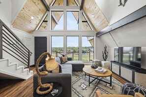 Open-concept living area w/ sleeper couch (Queen bed) and smart TV