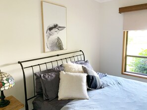 Bedroom 1 • Queen bed with walk-in-robe, ensuite and TV.