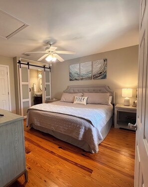 Primary bedroom w half bath, tv, closet and cabinet for unpacking
