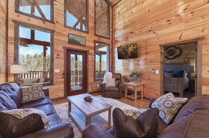 Comfortable living room with floor to ceiling windows. Also a smart TV on the wall for watching the big game on the weekend. You might even take a nap on these relaxing leather chairs and couches.