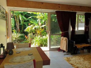 View from Dining area to back tropical garden. Insect screen on all external door and windows.