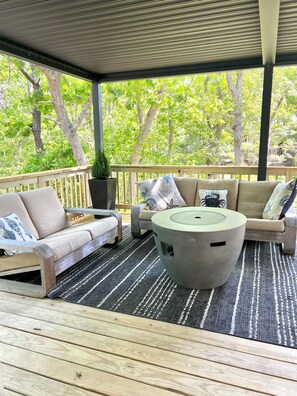 Outdoor patio with fire table and pergola. Restoration Hardware Furnature.
