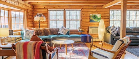 This sofa and chairs are parallel to the indoor wood stove