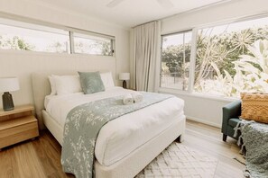 Master bedroom with backyard and pool vista, complete with a lavish ensuite and walk-in robe.