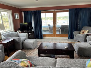 Living room with balcony facing due East for perfect sunrises and harbor views.