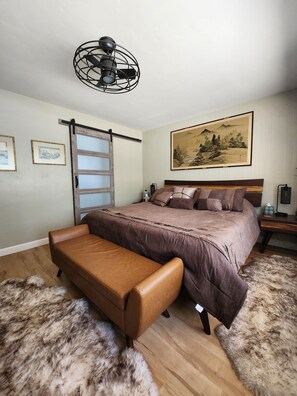 Master Bedroom-King bed with barn door to private bathroom.  large window view