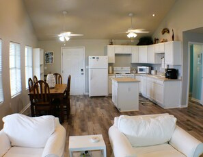 The kitchen connects to the dining area and the den.