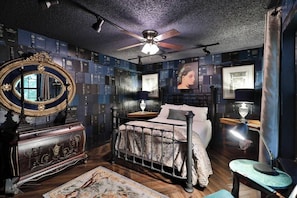 Located on the lower level, this queen sized bed and elegant furniture graces this room.