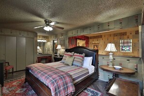 The upstairs area boasts this regal king sized bed with luxurious bedding.