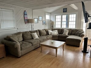 Living room with access to beach side deck and ocean views