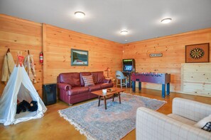 Lower level game room with arcade machine, foosball, darts, and board games! 