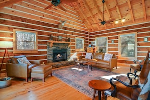 With an oversized family room, lofted ceiling, gas fireplace, rustic decor