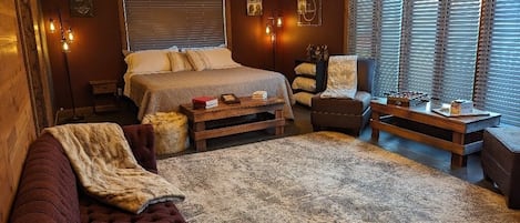 Main bedroom with king bed and a cozy fireplace.
