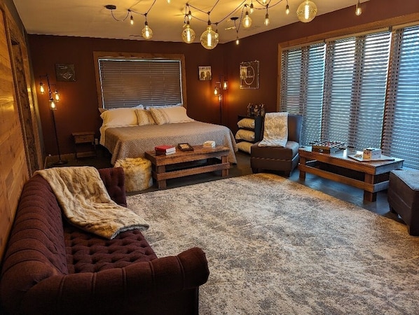 Main bedroom with king bed and a cozy fireplace.
