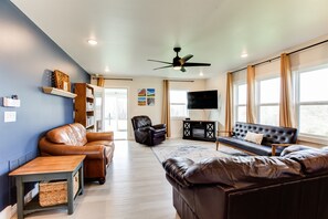 The living room has plenty of space for the whole family! The sunroom is out the door past the bookcase.