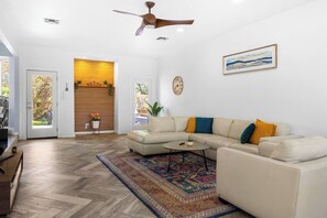 Relax in our bright living room—plush sofas, a 65-inch TV for movie nights. Elevate evenings with laughter-filled game nights. Craft cherished memories in this warm embrace, where every moment becomes extraordinary.