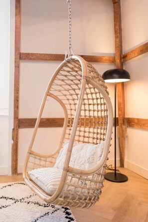 The hanging chair made of reeds is a fun and comfortable seating option