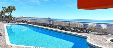 Poolside view with ocean scenery, perfect for relaxing and sunbathing