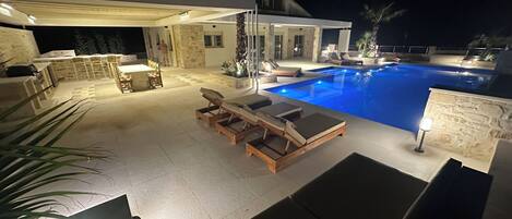 Night time poolside relaxation area