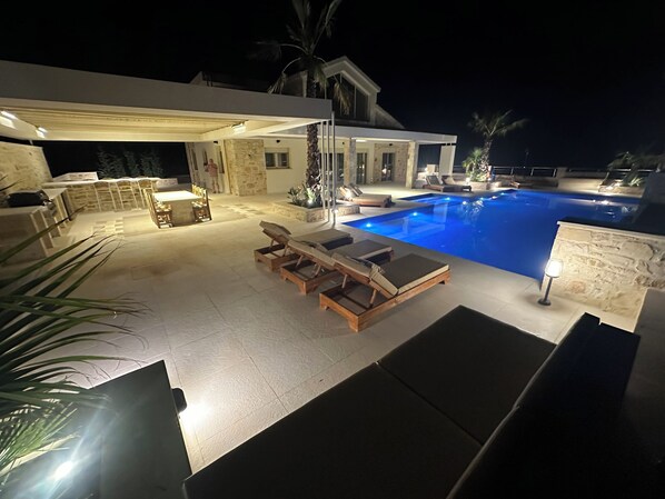 Night time poolside relaxation area