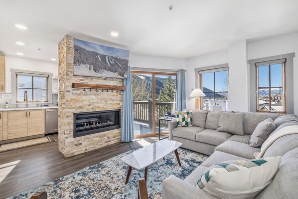Living room, fireplace, deck and kitchen view