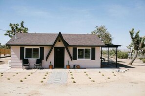 Front of house with barrel cactus.