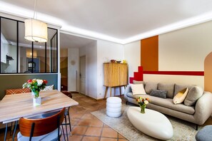 Comfortable living room with convertible sofa, TV