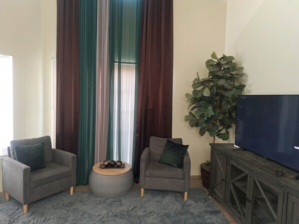 Decorated living room area with 15 foot ceilings. 