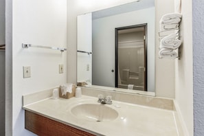 Each room is equipped with a convenient sink, mirrors, and towels located outside the bathroom.