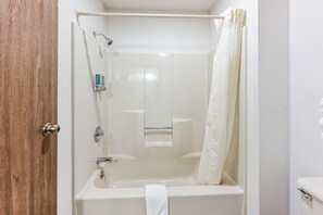 Experience simplicity and comfort in our thoughtfully designed bathroom. Featuring a standard bathtub, it's a welcoming space to refresh after a day of exploration. The separate toilet area adds privacy, allowing for a tranquil experience. With clean lines and essential amenities, this bathroom provides a convenient and calming space during your stay.