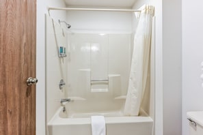 Experience simplicity and comfort in our thoughtfully designed bathroom. Featuring a standard bathtub, it's a welcoming space to refresh after a day of exploration. The separate toilet area adds privacy, allowing for a tranquil experience. With clean lines and essential amenities, this bathroom provides a convenient and calming space during your stay.