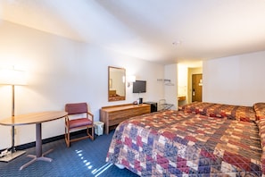 Take in the diagonal view of this welcoming room, facing Main Street (HWY K) — ideal for keeping an eye on your outdoor equipment. Two Queen beds, a sitting area, and essential amenities ensure a relaxed and enjoyable stay, with a microwave available in the lobby.