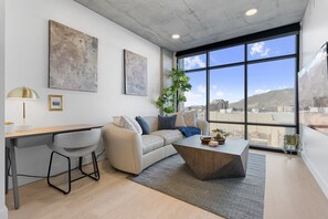 Floor to ceiling windows frame views of the capitol and downtown from the designer soft leather couch