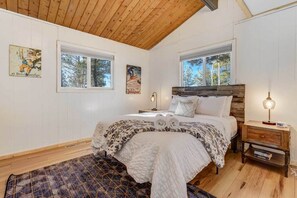 Recharge in our queen bedroom after your journey, embracing relaxation for an enjoyable vacation ahead.
