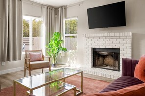living room with smart tv- please note that the fireplace is not operational