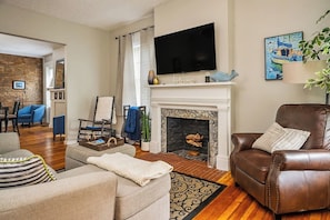 Unit 40: Our cozy living room with sofa and leather reading chair to read and watch tv or stream movie.