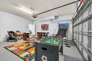 Refreshing Game Room of the Home in Kissimmee Florida - Enjoy Competitive Fun in the Game Room with a Foosball Table - A vibrant atmosphere that ignites the spirit of play and competition