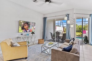 Scenic Living Area of the Townhouse in Davenport Florida - View of the pool from the outside - Smart TV and Netflix - Cozy seating area conducive to relaxation and socializing