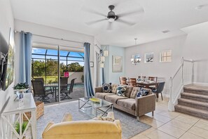 Lavish Living Area of the Townhouse in Davenport Florida - Beautiful living room with an open layout, creating a sense of spaciousness - Smart TV and Netflix - Open-concept living area seamlessly connected to a stylish dining space
