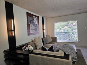 Living Room:  We infused this living space with a sense of tranquility and serenity to reflect the unique taste and personality through carefully curated decor.