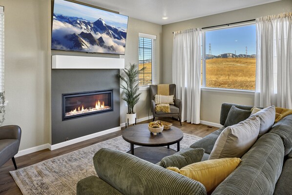 Living room with fireplace and tv mounted above it