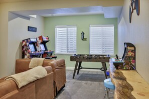 Game room with foosball, arcade games, and leather couch