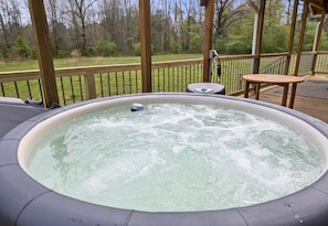 Unwind in this bubbling hot tub while soaking in the serene view of nature. It’s the perfect way to relax after a day of adventures.
