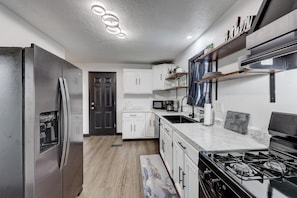 When parking in the back, you'll enter from the back door and find this dreamy kitchen.