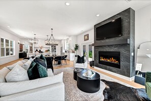 First floor living area, dining area, kitchen with entryway to patio.